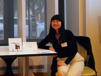 Sunnina Chen sitting by her book, "dwelling."